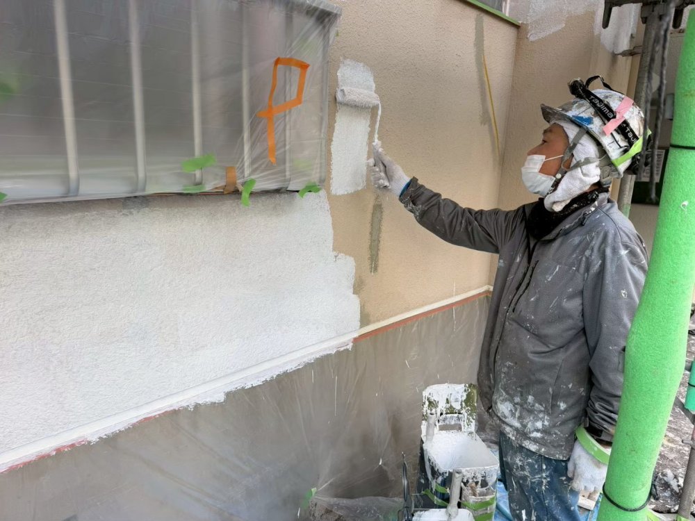 中塗りで塗膜の厚みを確保し、三芳町の集合住宅を雨や紫外線から守る下地を形成します。 写真
